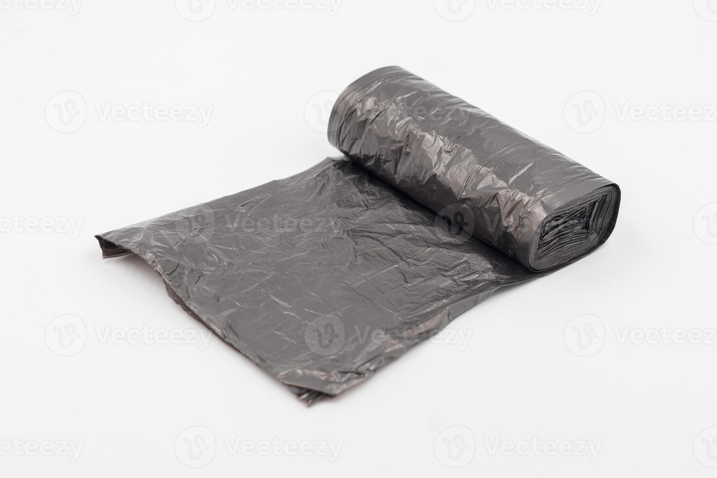 Black plastic garbage bags on white background, Roll of garbage bags on white background photo