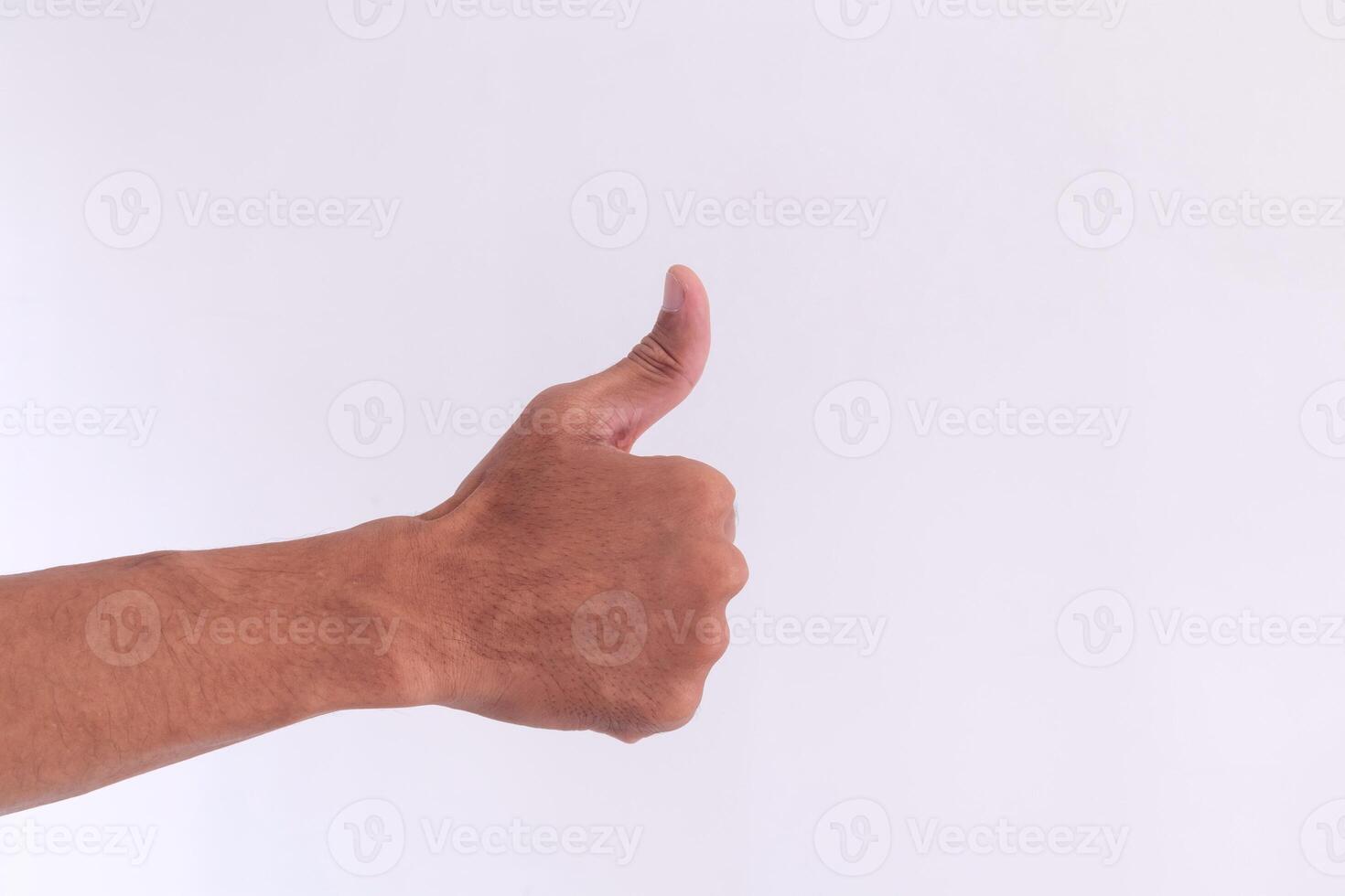 Hand of man showing thumb up gesture on a white background. Sign fingers Like or OK. photo