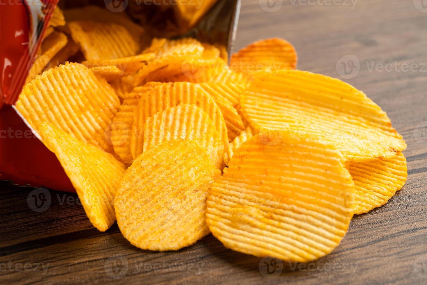 Potato chips, delicious BBQ seasoning spicy for crips, thin slice deep fried snack fast food in open bag. photo