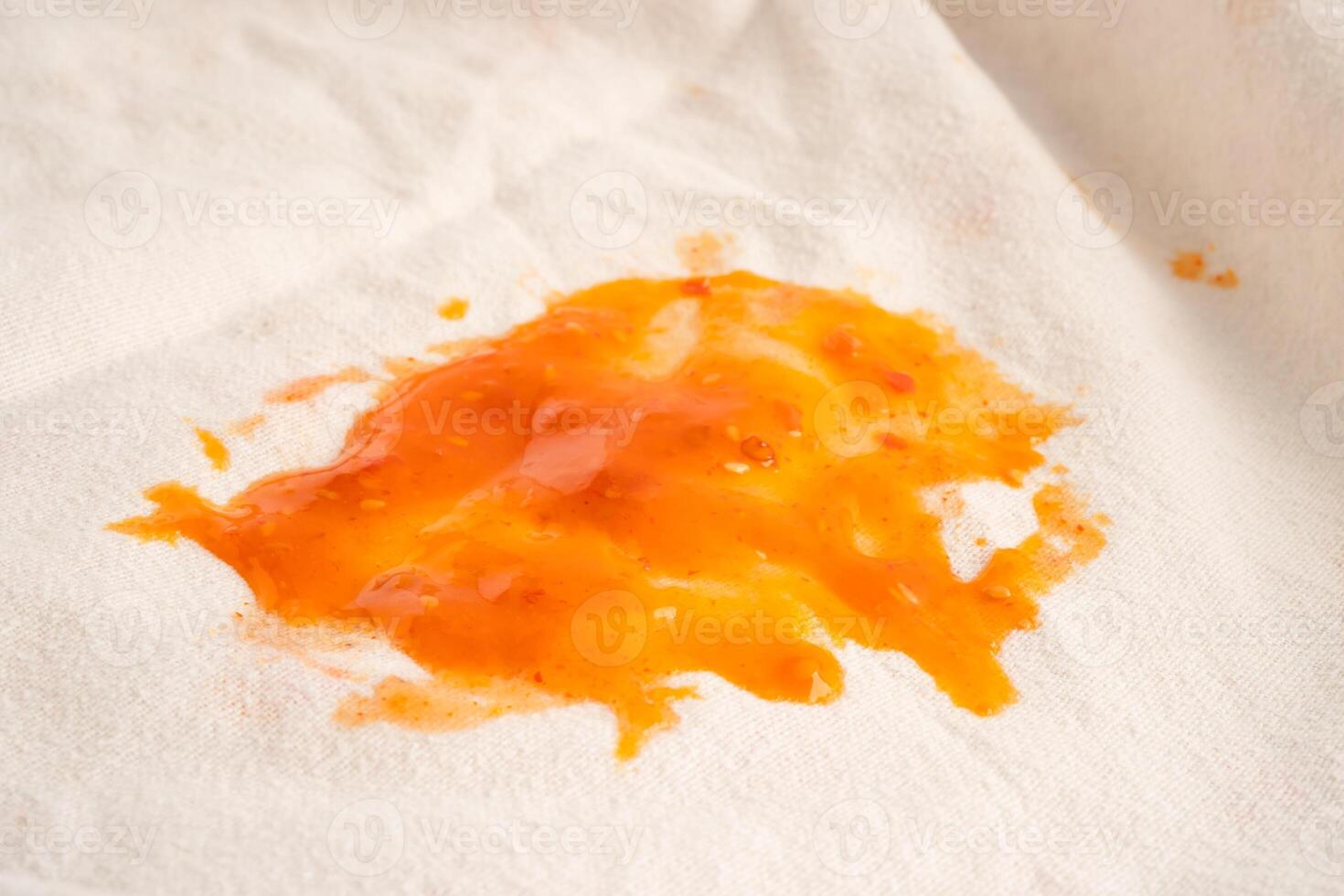 Dirty tomato sauce stain or ketchup on cloth to wash with washing powder, cleaning housework concept. photo