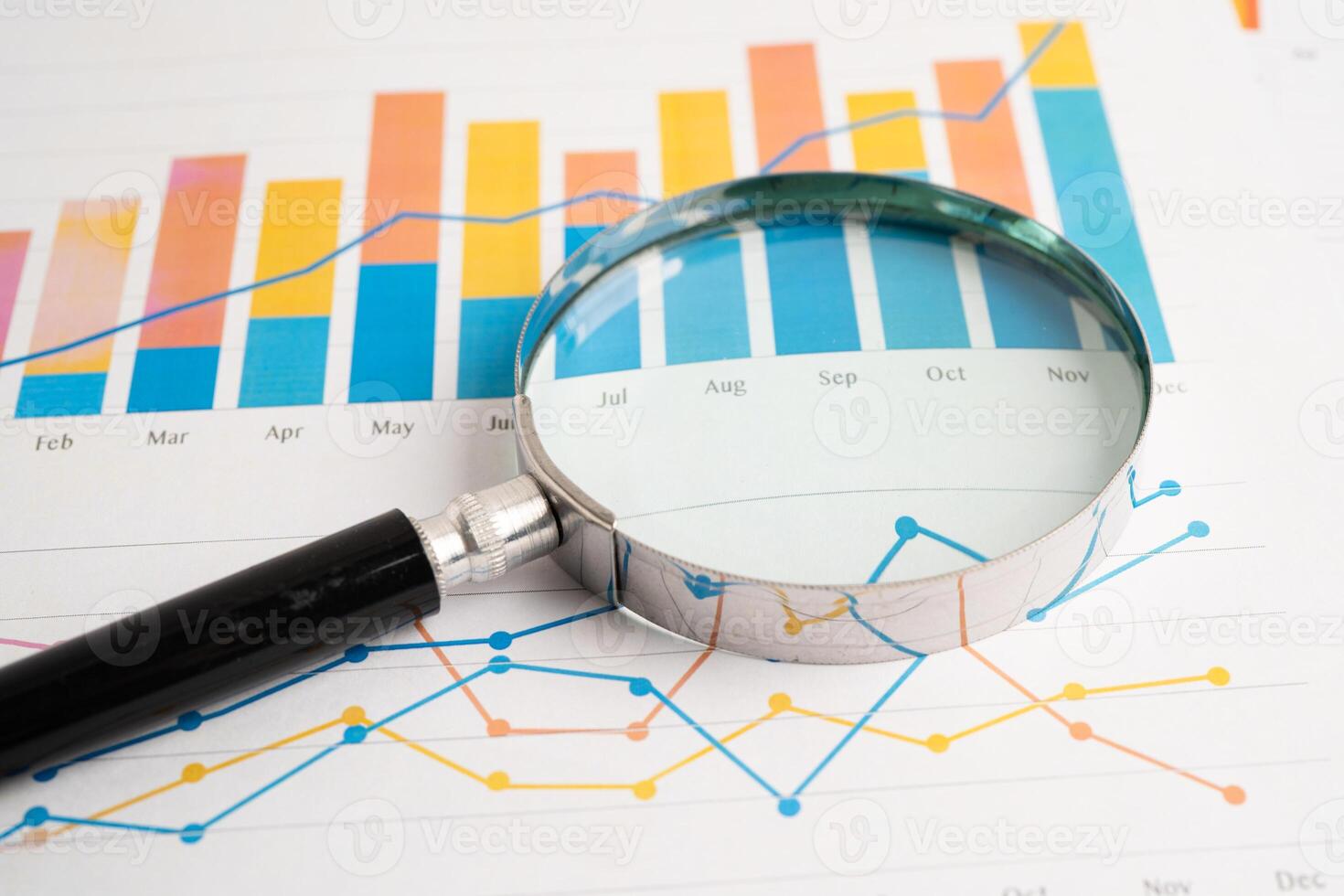 Magnifying glass on spreadsheet and graph paper. Financial development, Banking Account, Statistic, Investment Analytic research data economy, Business. photo