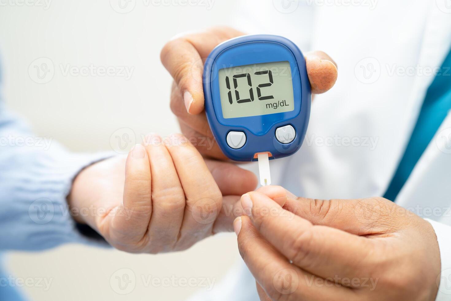 Doctor check diabetes from finger blood sugar level with finger lancet. photo