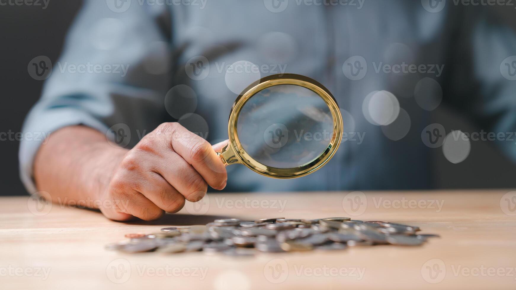 One person in business meticulously analyzes coins under magnifying glass, researching innovative concepts and strategies, discovering successful solutions and breakthrough ideas for financial growth photo