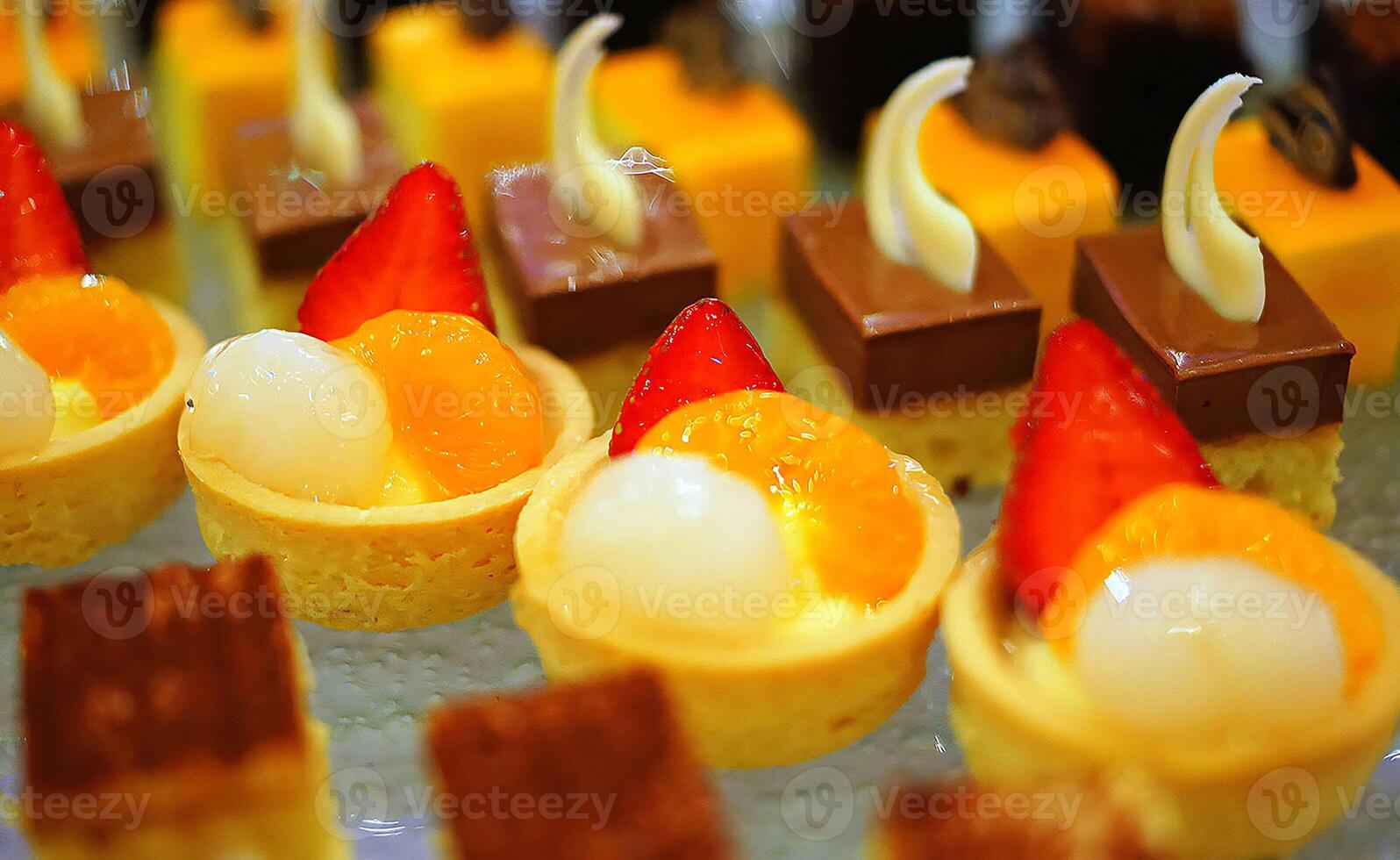 Beautiful multicolored decorated baked sweet tasty party cakes or catering cakes for party, bar dessert selection with cake, pie and pastries catering banquet, coffee break buffet at a conference photo