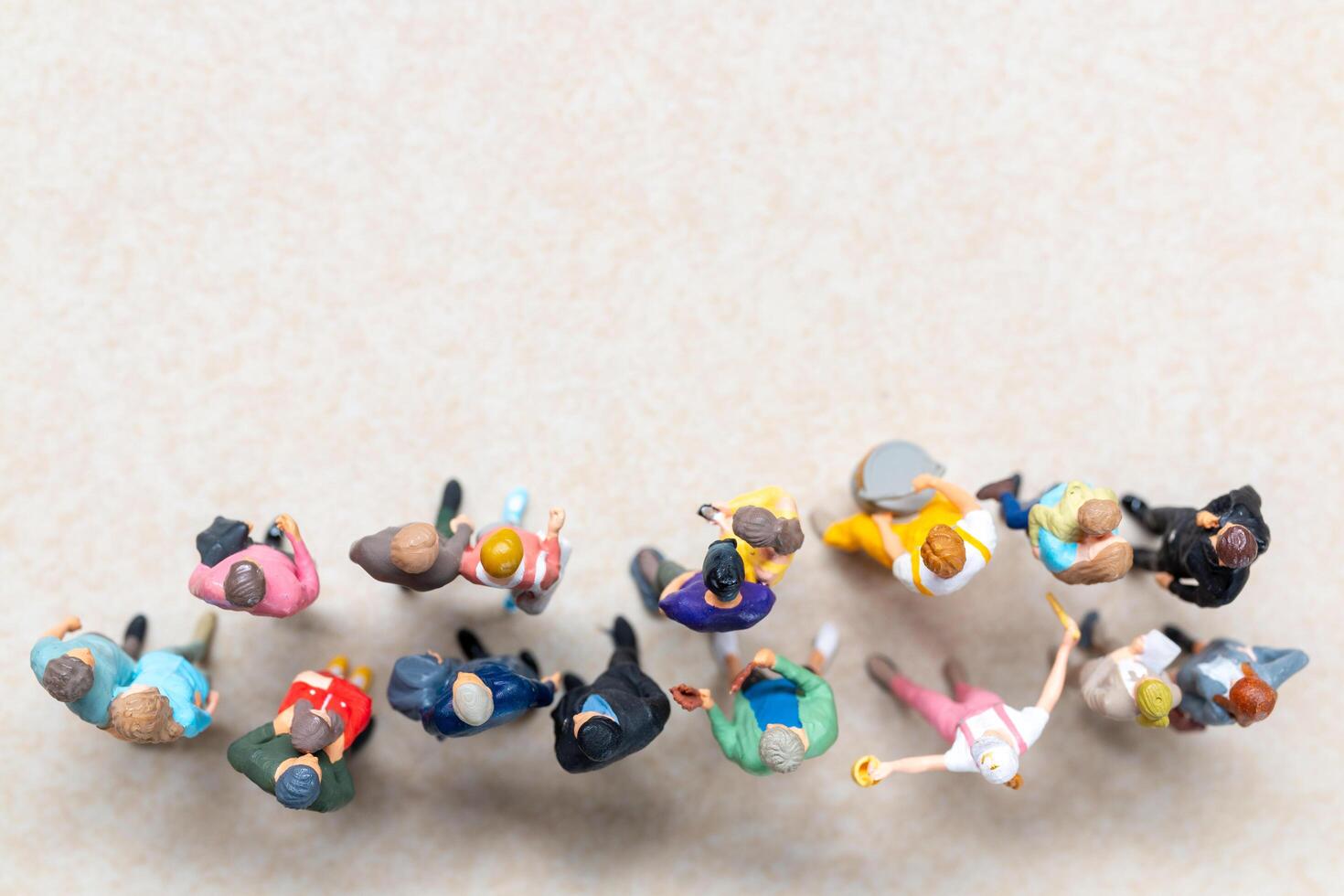 Top-down view of a group of miniature people showing different clothing and poses. photo