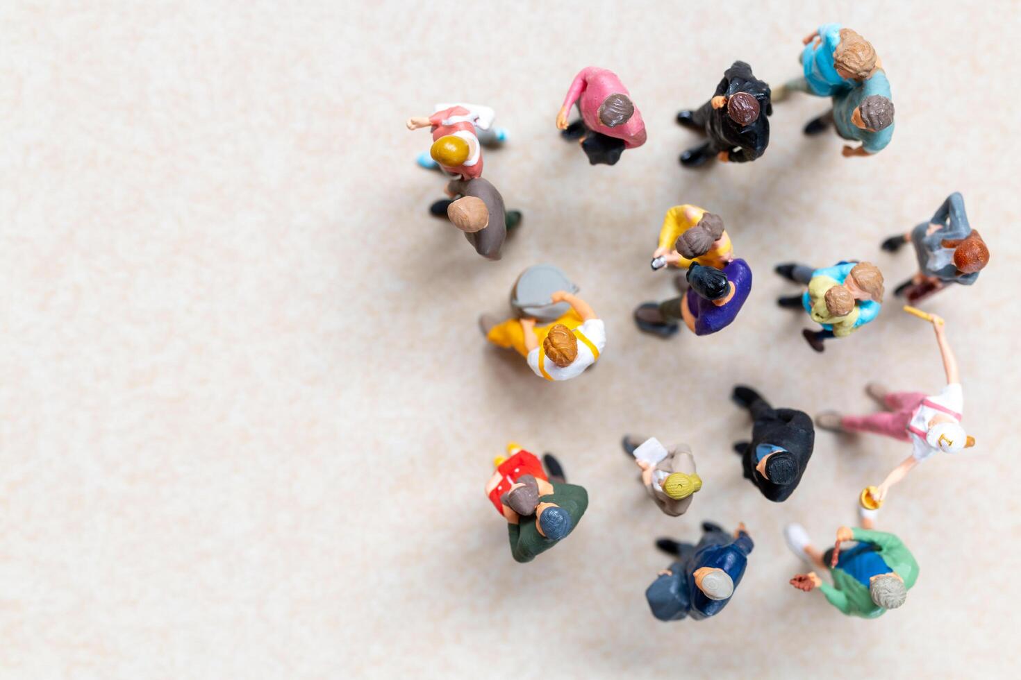 Top-down view of a group of miniature people showing different clothing and poses. photo
