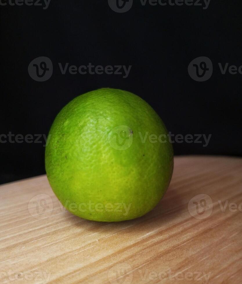 one lime on a black background photo