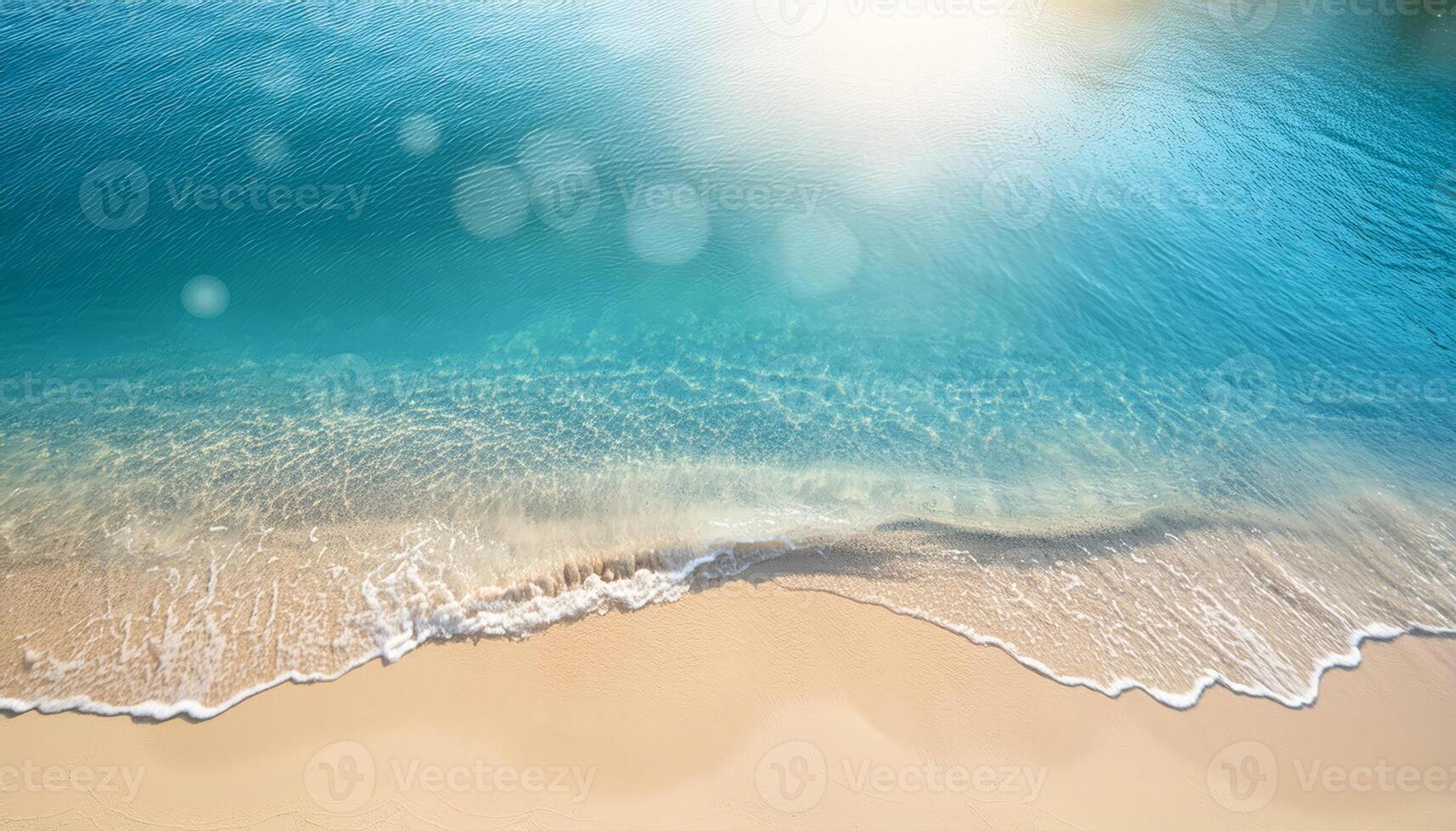 A gentle wave laps at the shore of a sunny beach photo