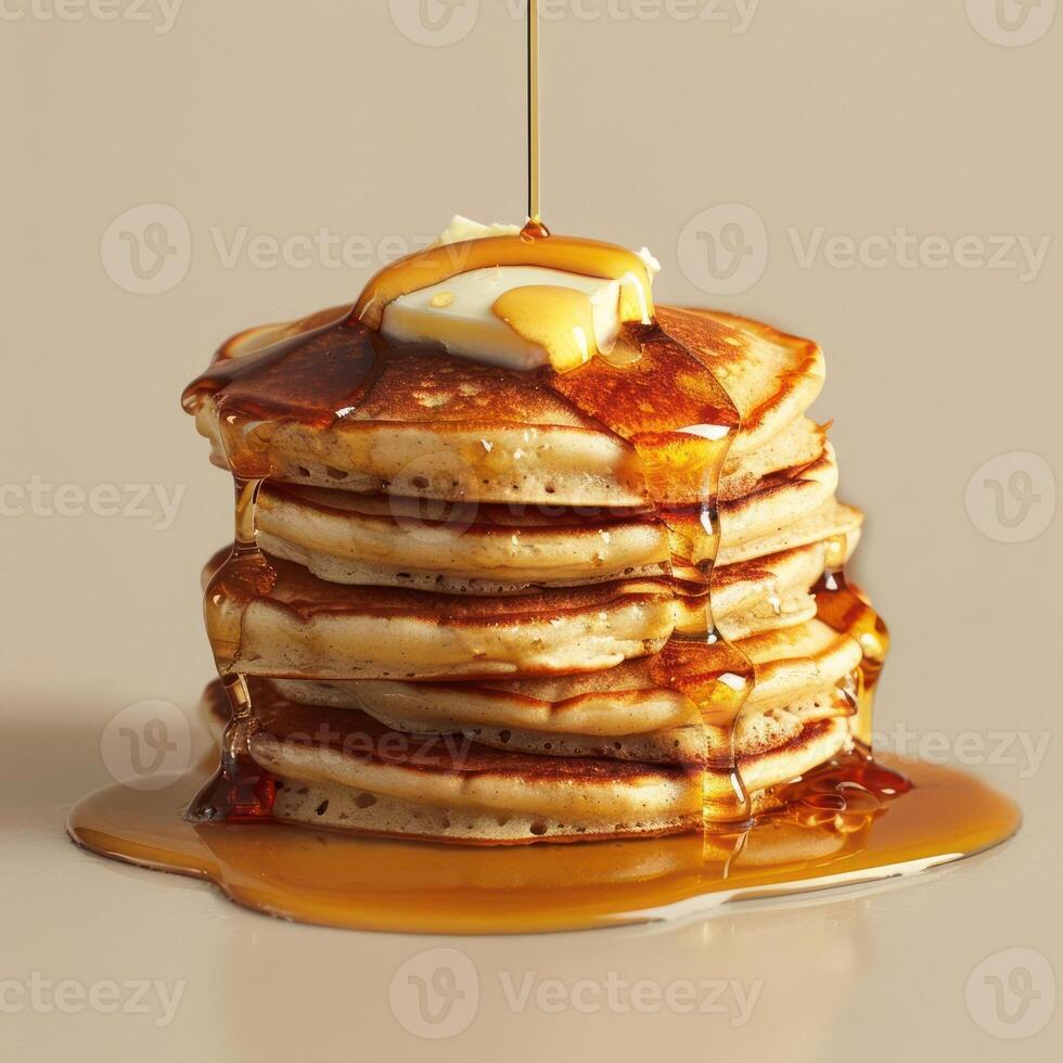 araffe with syrup and butter on top of a stack of pancakes photo
