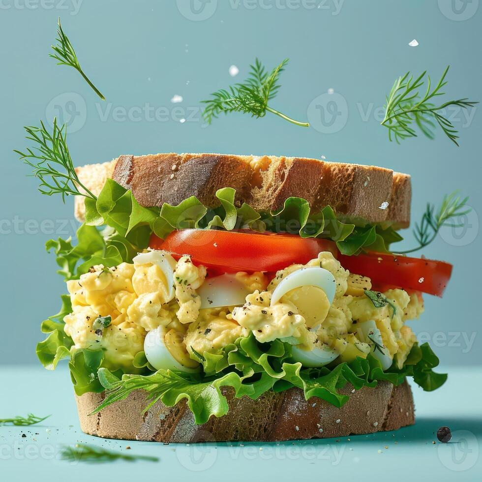 a sandwich with eggs, tomatoes, lettuce, and tomatoes photo