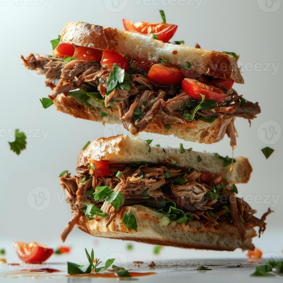 a sandwich with meat and vegetables on it being lifted photo
