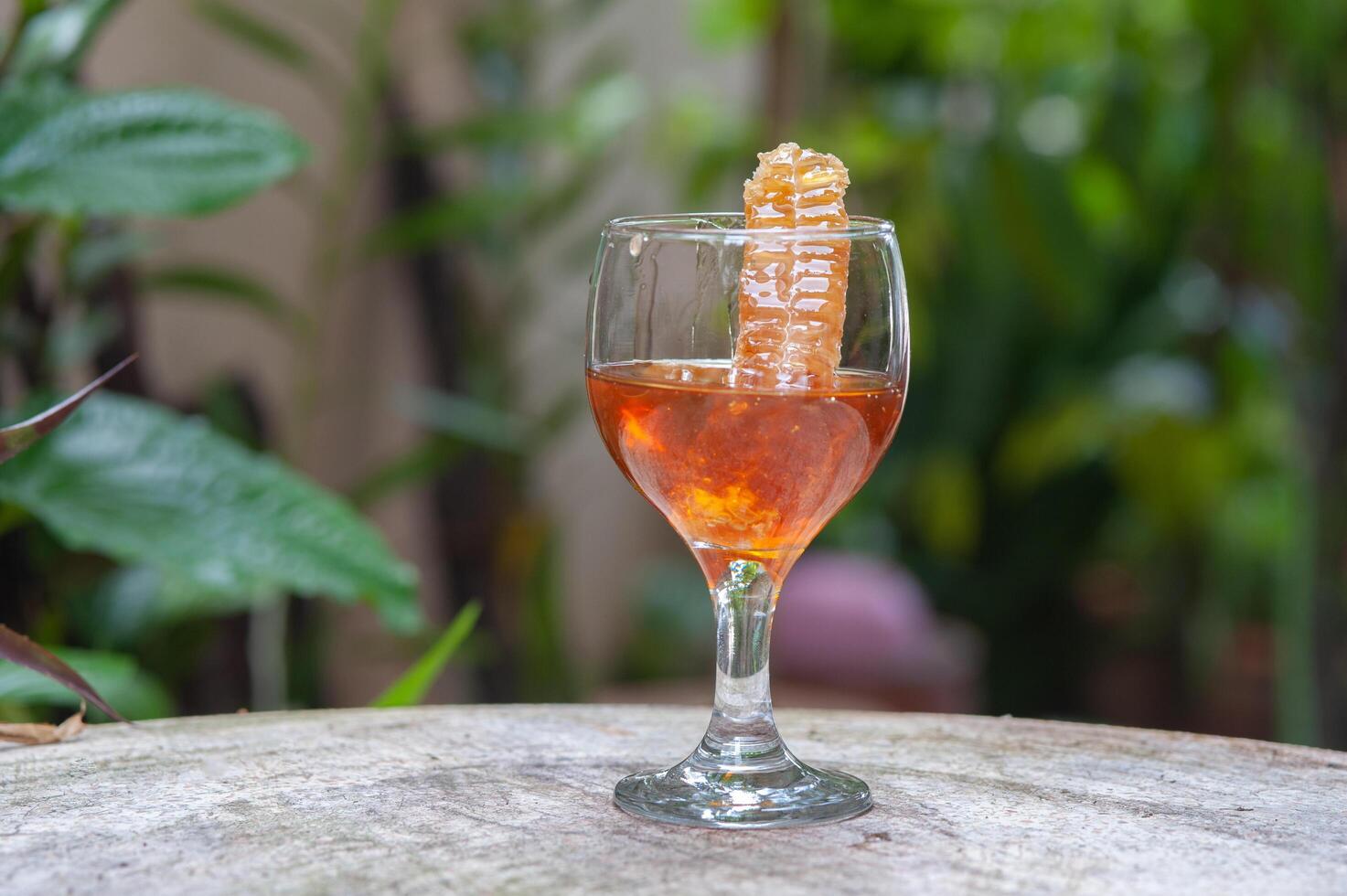 Wild honey, natural organic food, in a glass bottle photo