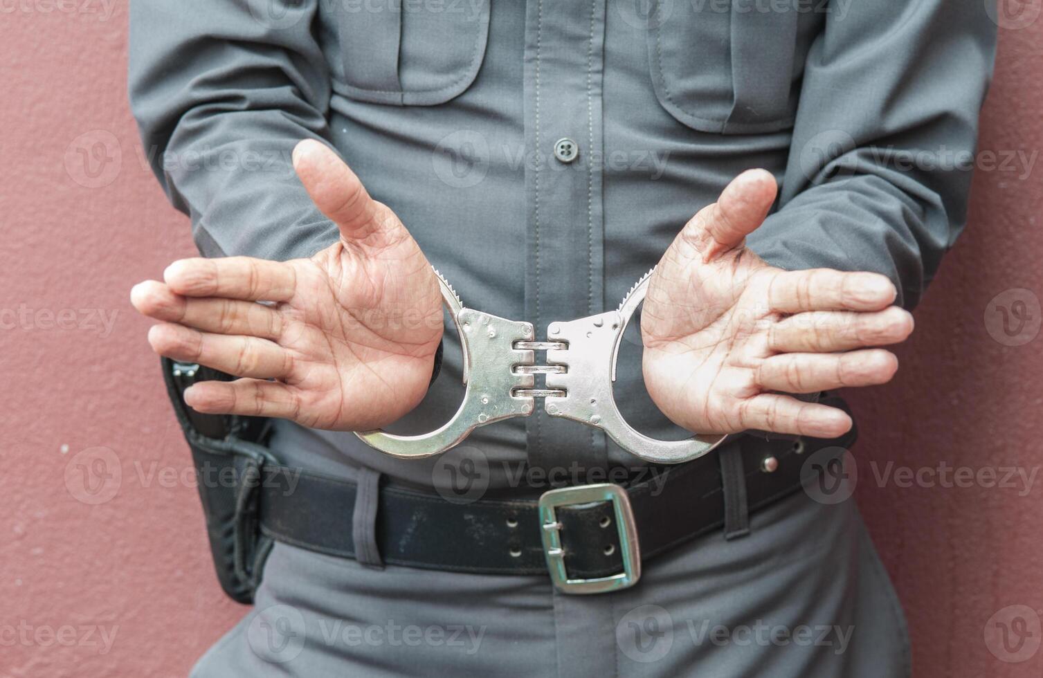 Police demonstrate the use of handcuffs photo