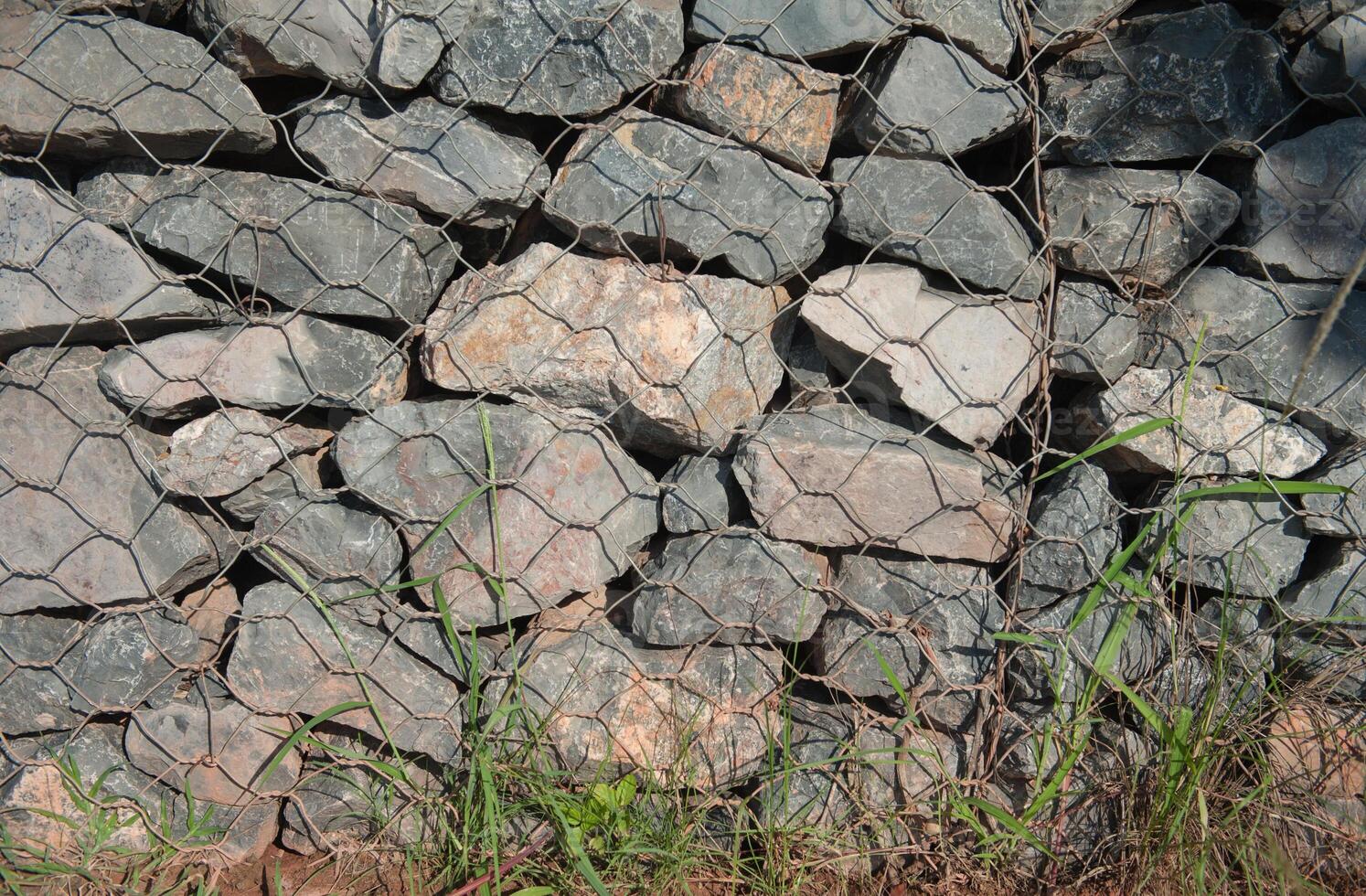 Fill in rocks to create a barrier to prevent erosion from waves. photo