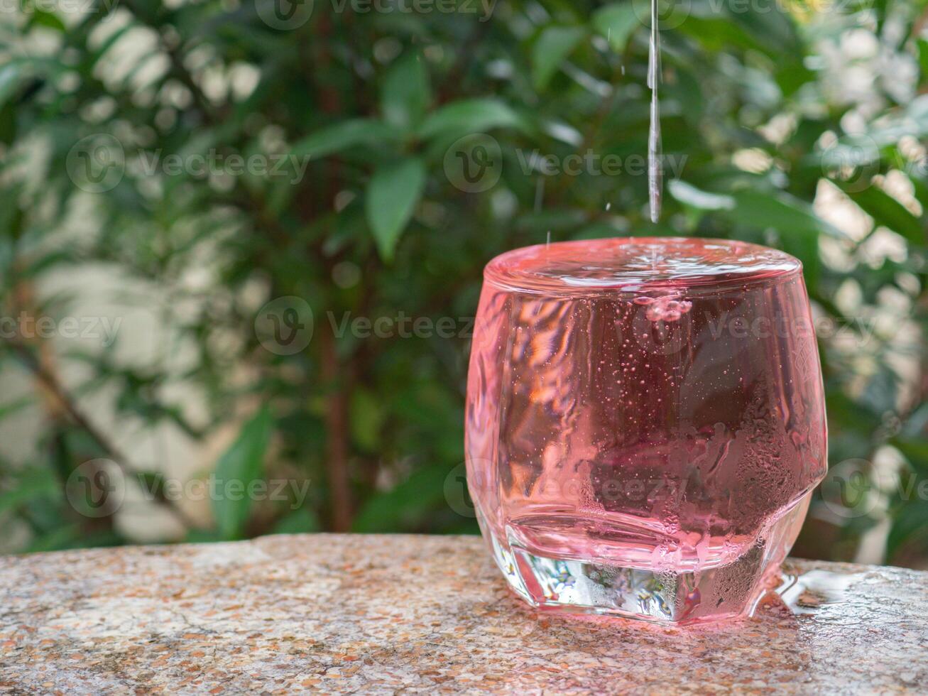 Cold red sweet drink in glass photo