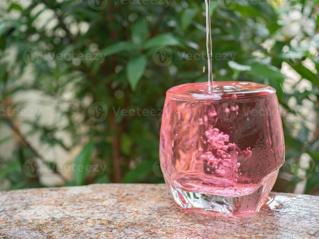 Cold red sweet drink in glass photo