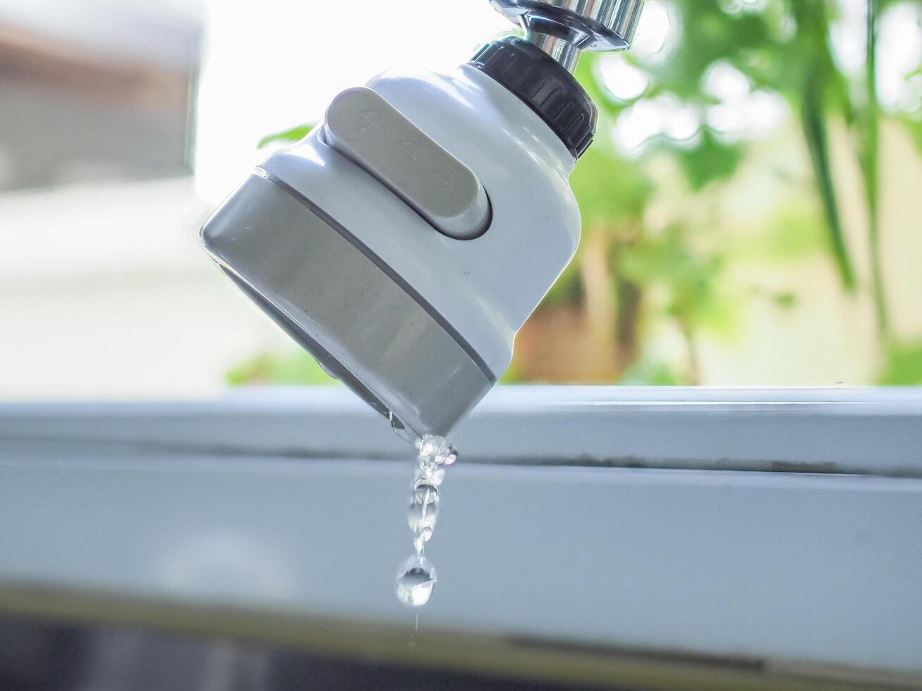 Faucet dripping water at the sink photo