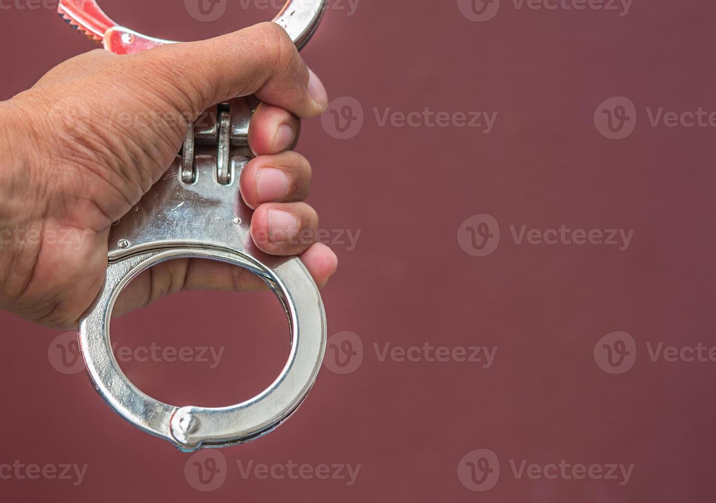 Police demonstrate the use of handcuffs photo