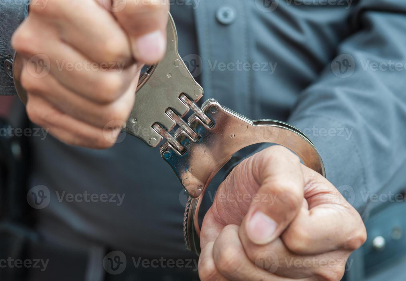Police demonstrate the use of handcuffs photo