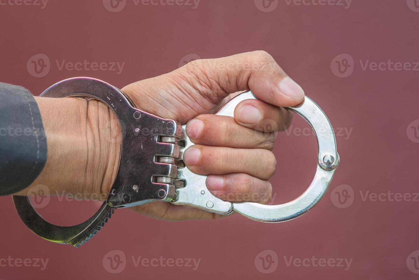 Police demonstrate the use of handcuffs photo