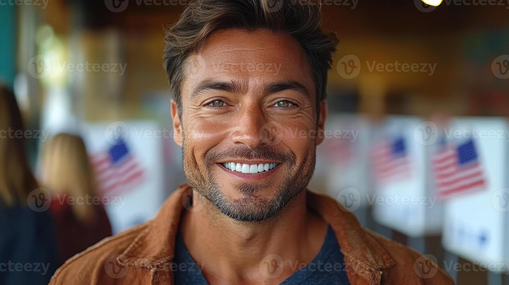 A cheerful man stands at a polling station filled with voting booths photo