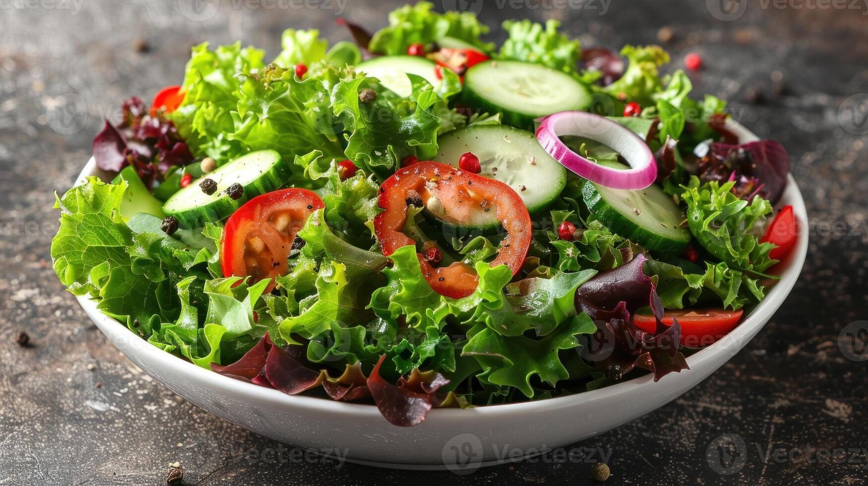 Crisp lettuce, vibrant tomatoes, and sliced cucumbers create a refreshing salad photo