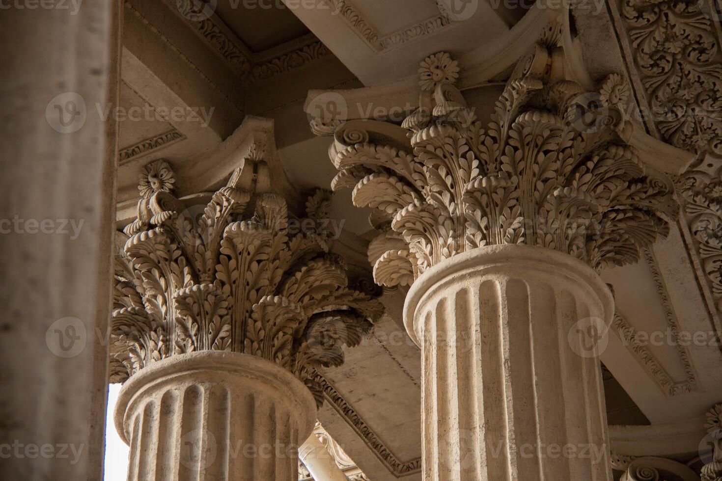 Ornate Classical Columns of Antique Design with detailed Corinthian Capitals Decorated with intricate Leaf pattern. Architectural elements Historic building characterized exquisite craftsmanship photo
