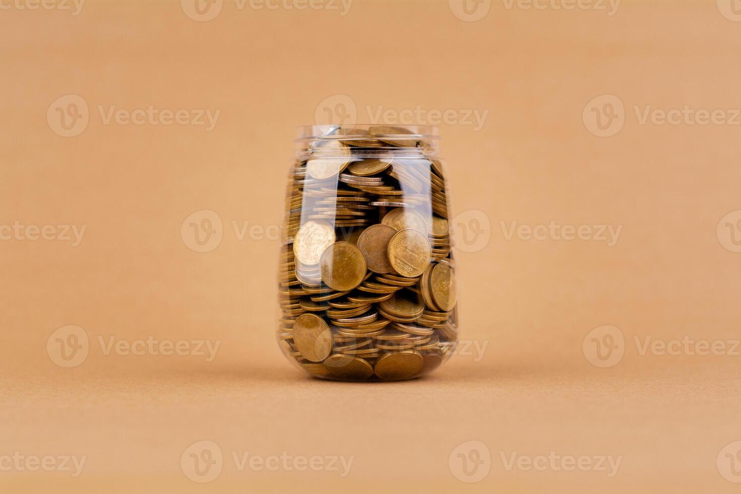Saving coins in a glass jar, planning your finances, creating a good financial path. Financial and investment success goals photo