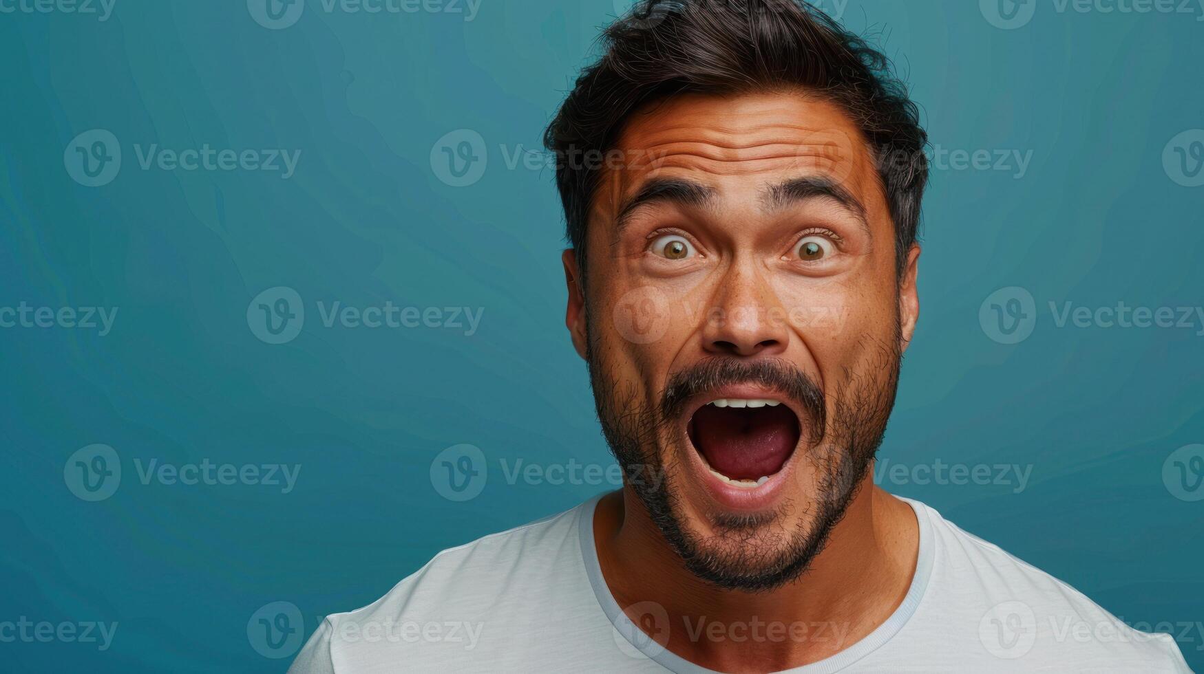 A man with a joyful expression showcases his excitement with an open mouth photo