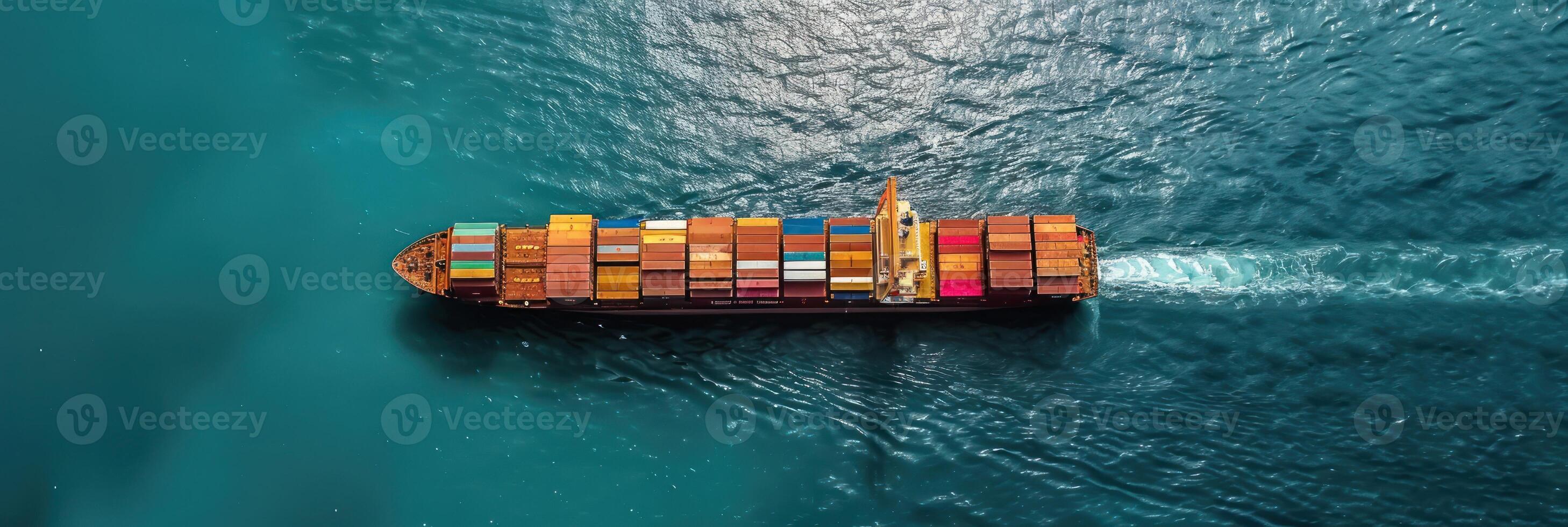 A large container ship with colorful cargo containers sails across a blue ocean photo