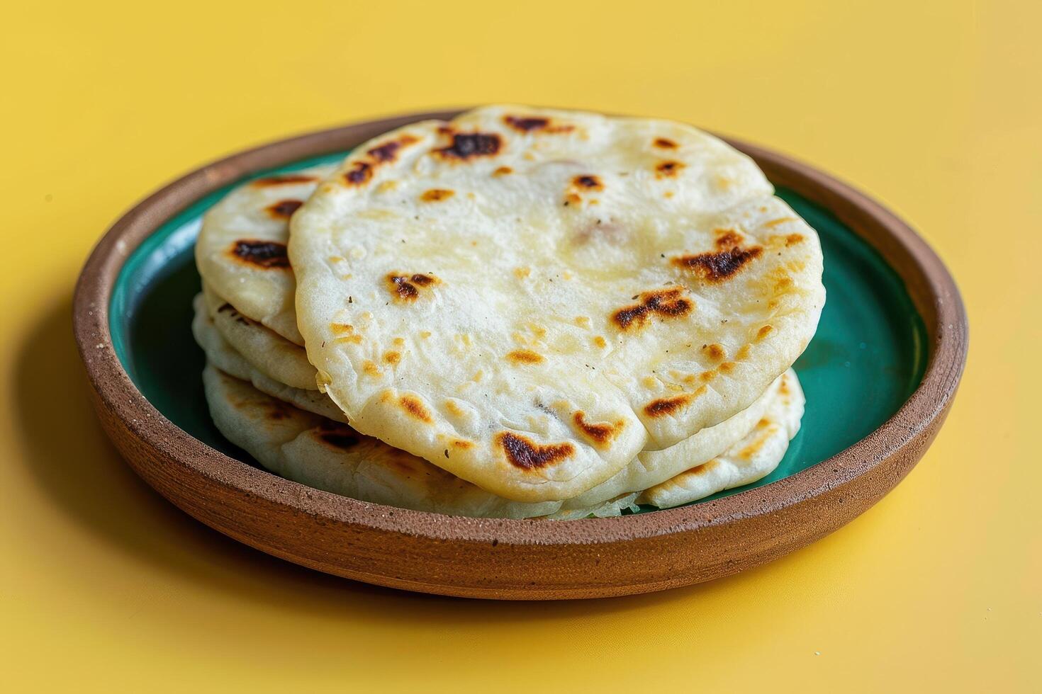 Stack of Flatbreads on a Green and Brown Plate photo
