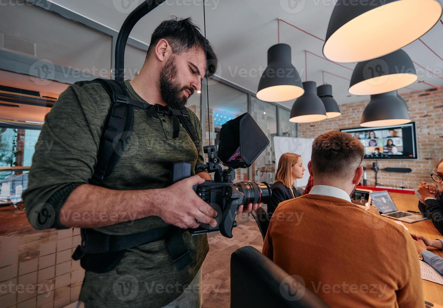Capturing Corporate Dynamics. Videographer Films Business Meeting in Modern Office. photo