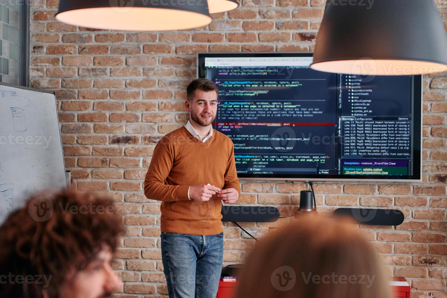 In a corporate setting businessman leads a meeting, passionately presenting a business plan to his attentive team, fostering collaboration and strategic thinking photo