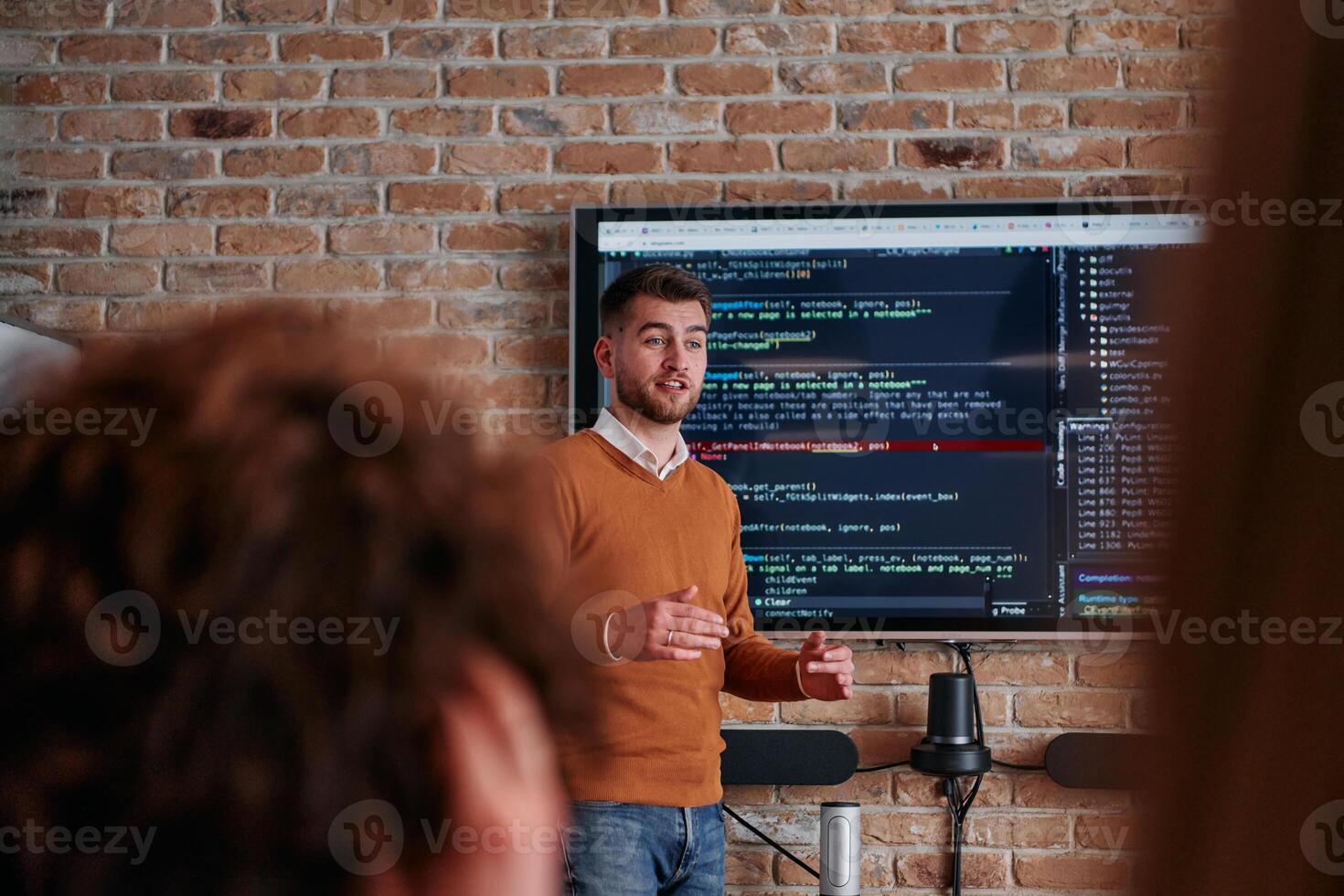 In a corporate setting businessman leads a meeting, passionately presenting a business plan to his attentive team, fostering collaboration and strategic thinking photo