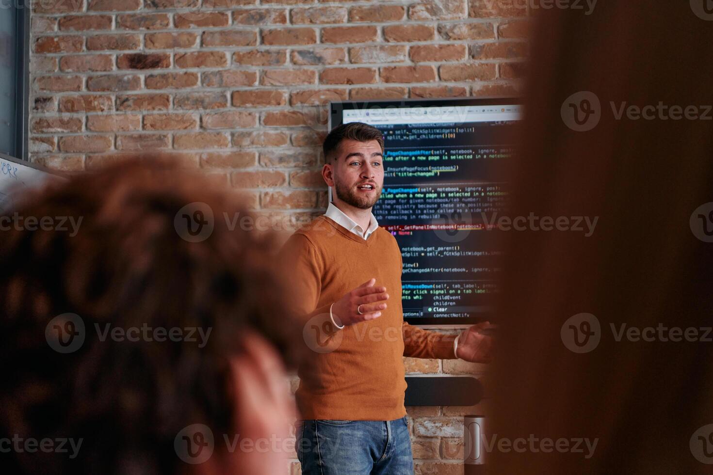 In a corporate setting businessman leads a meeting, passionately presenting a business plan to his attentive team, fostering collaboration and strategic thinking photo