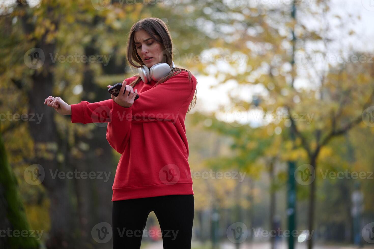 Athletic young woman taking a breath and relaxing after jogging and stretching. Woman Training and Workout Exercises On Street. photo