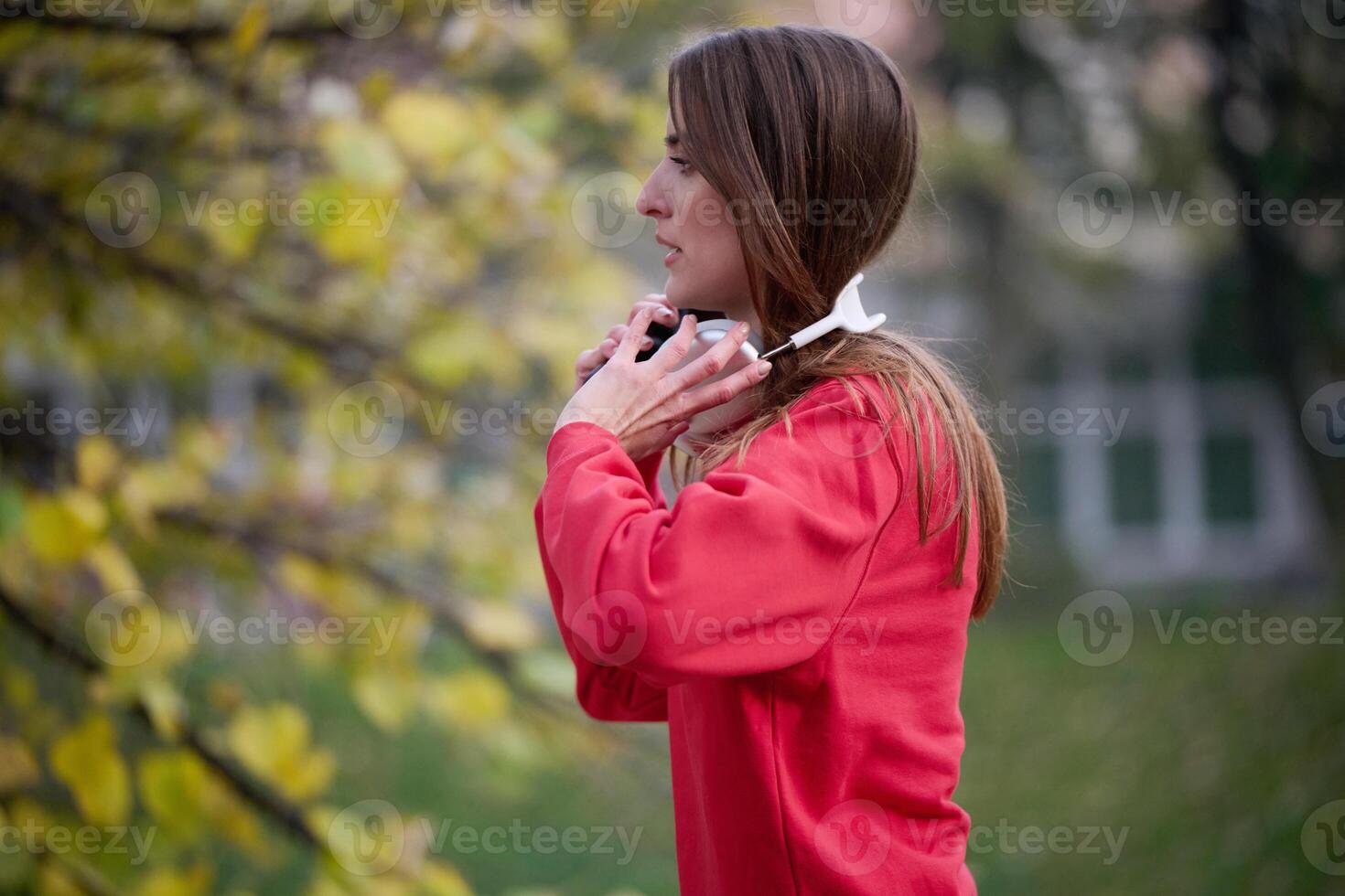Athletic young woman taking a breath and relaxing after jogging and stretching. Woman Training and Workout Exercises On Street. photo