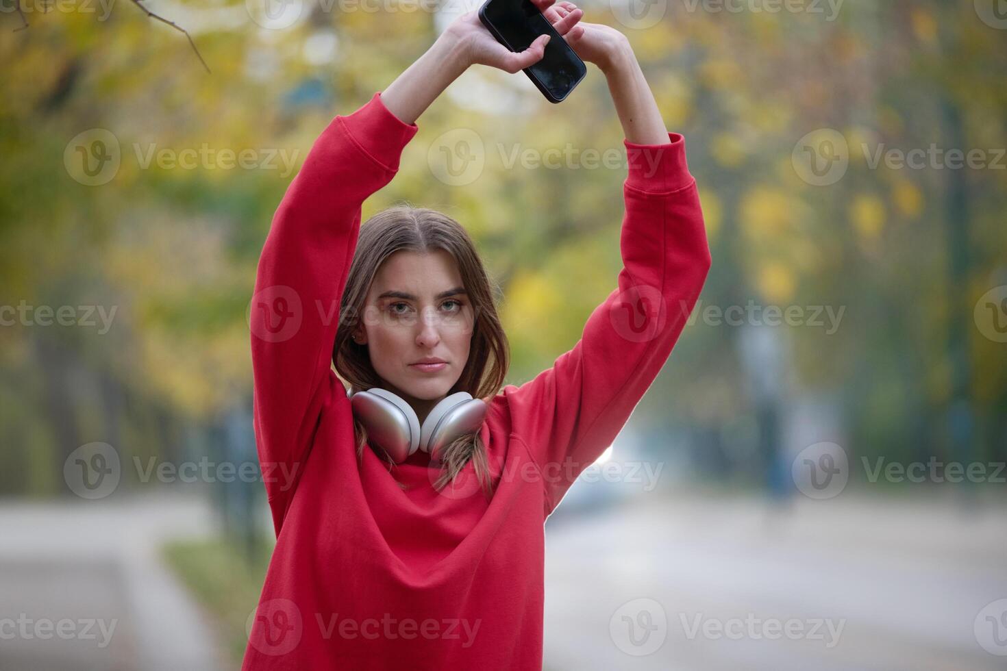 Athletic young woman taking a breath and relaxing after jogging and stretching. Woman Training and Workout Exercises On Street. photo