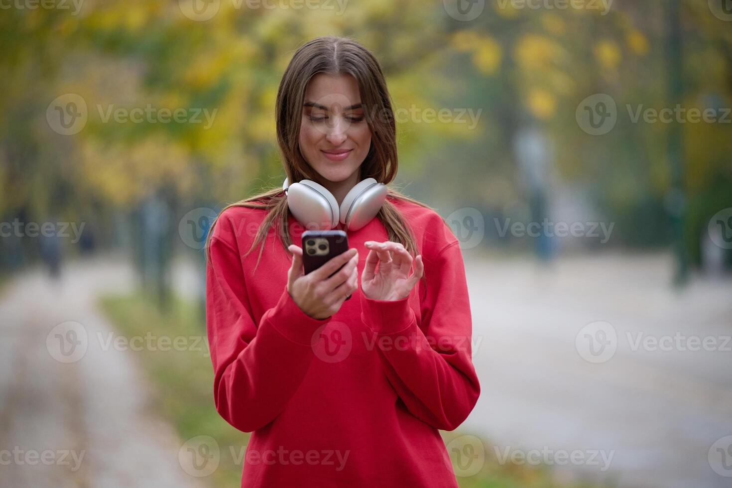 Athletic young woman taking a breath and relaxing after jogging and stretching. Woman Training and Workout Exercises On Street. photo