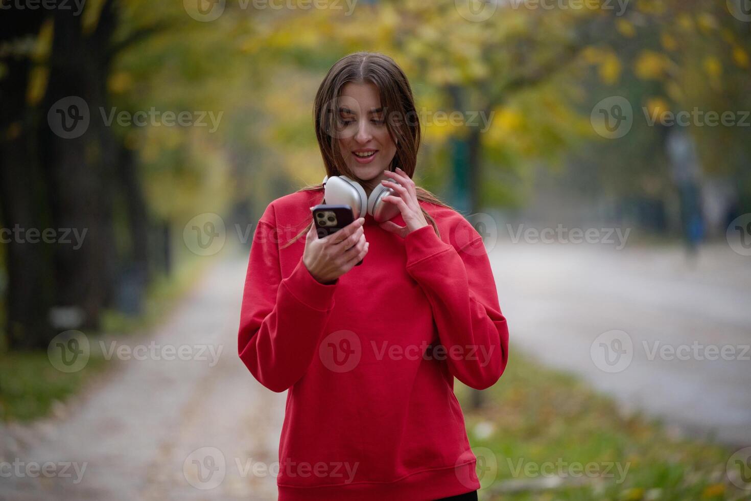 Athletic young woman taking a breath and relaxing after jogging and stretching. Woman Training and Workout Exercises On Street. photo