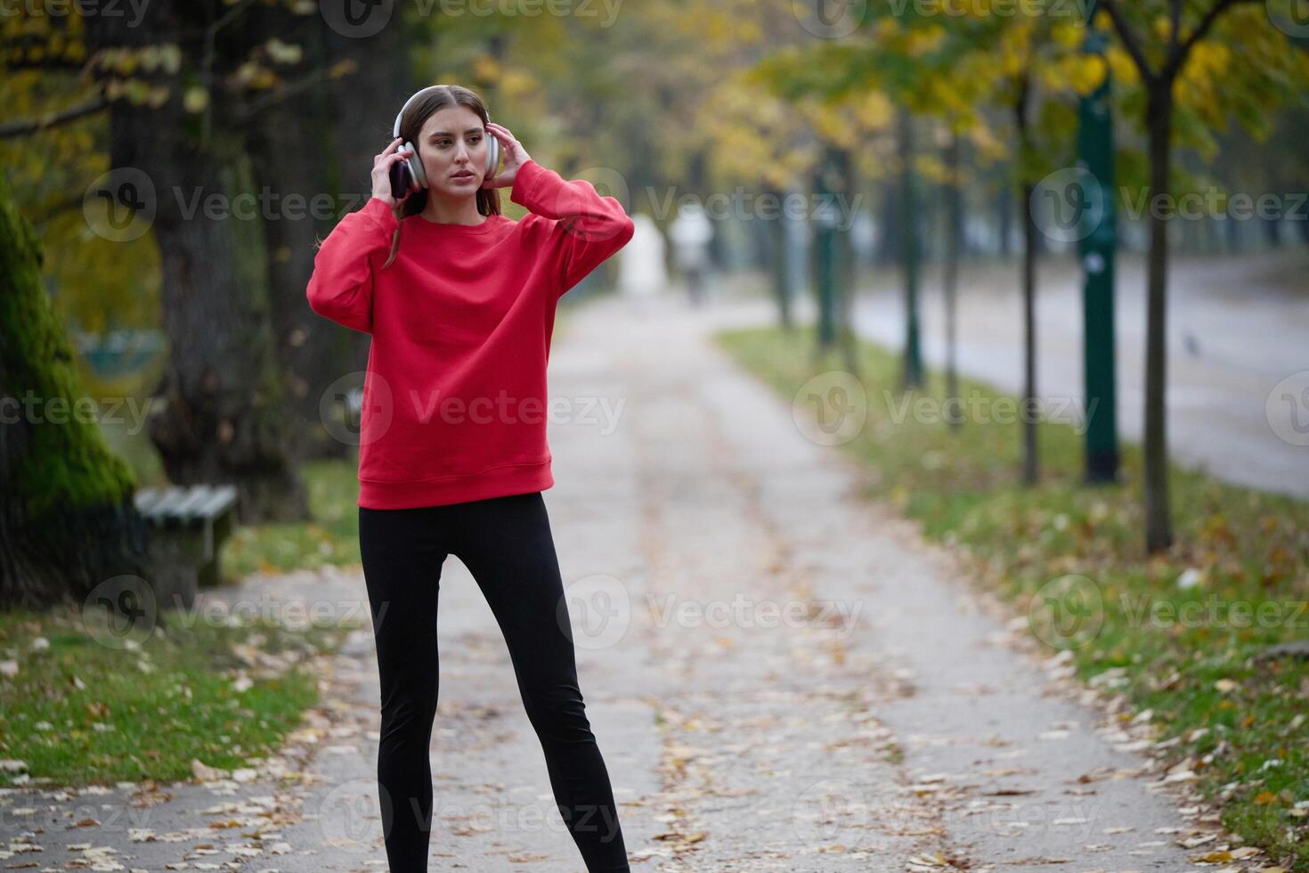 Athletic young woman taking a breath and relaxing after jogging and stretching. Woman Training and Workout Exercises On Street. photo