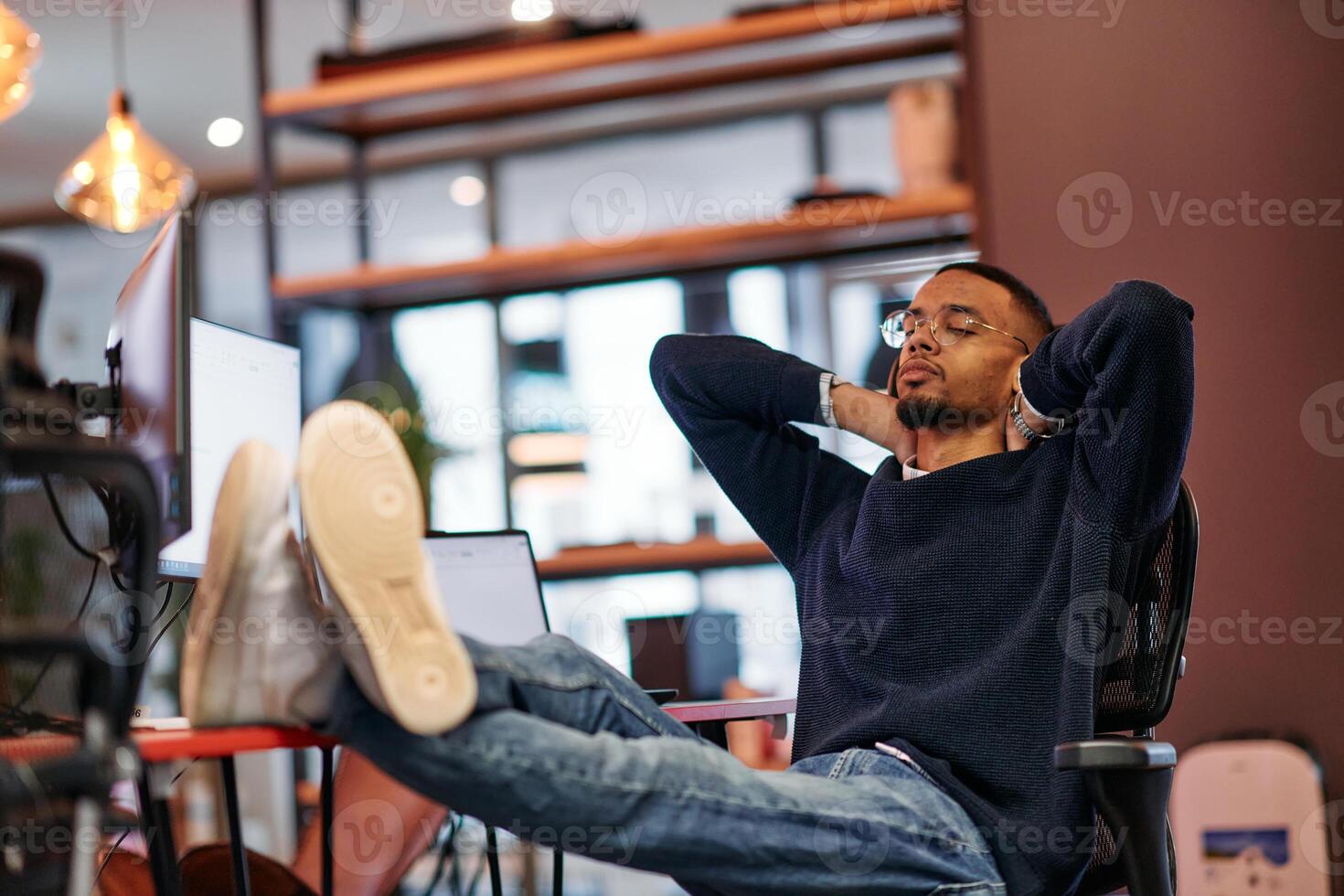 Exhausted African American Programmer Resting at Work. photo