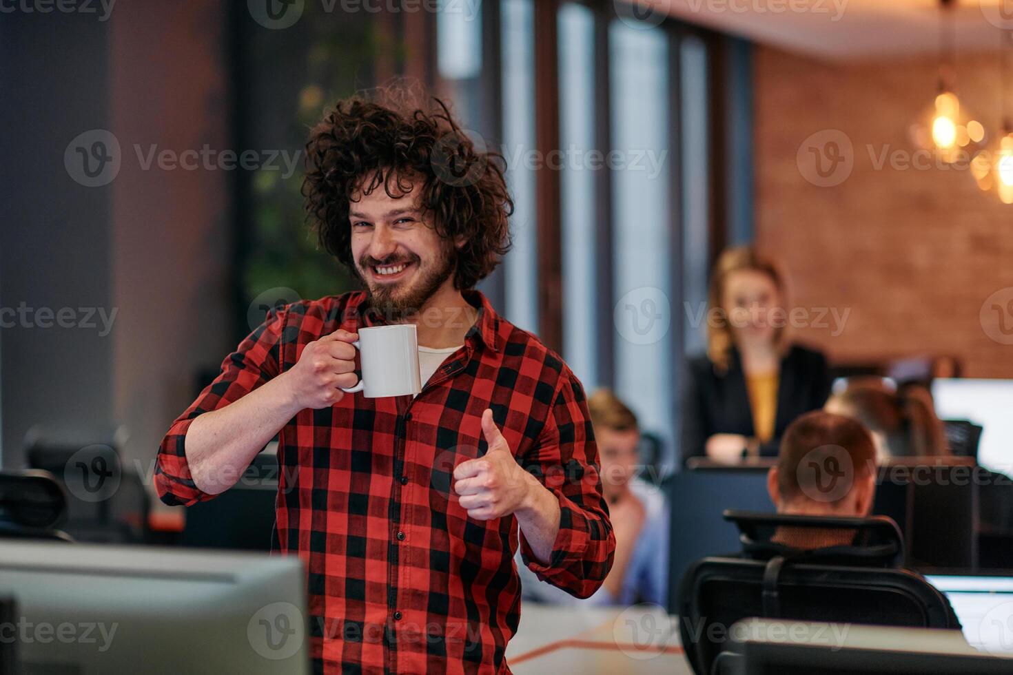 Focused Professional. Interesting Man with Coffee Cup in Office Surrounded by Computers. photo