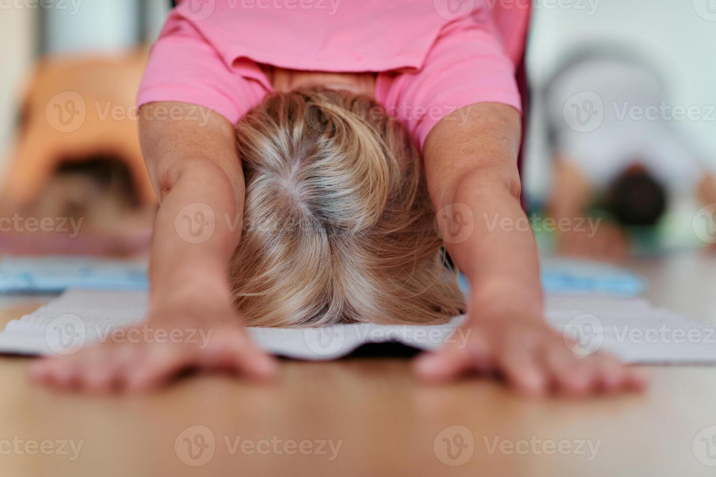 Senior Woman Practicing Back Stretches in a Sunlit Space for Optimal Health and Well Being photo