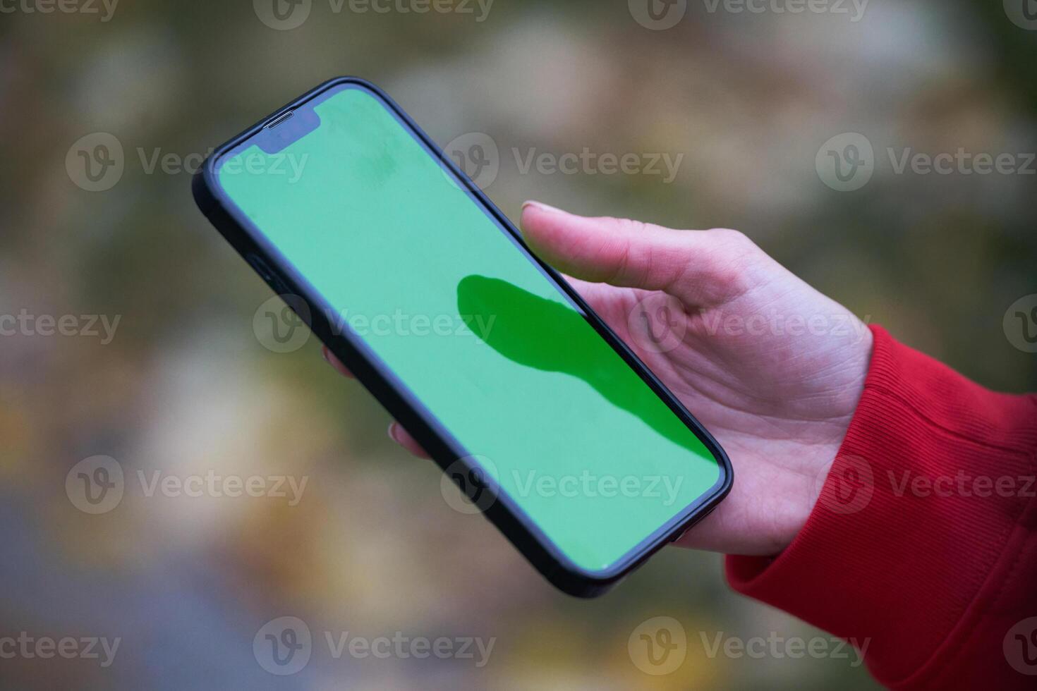 Tired fitness woman after workout and use smartphone with green screen photo