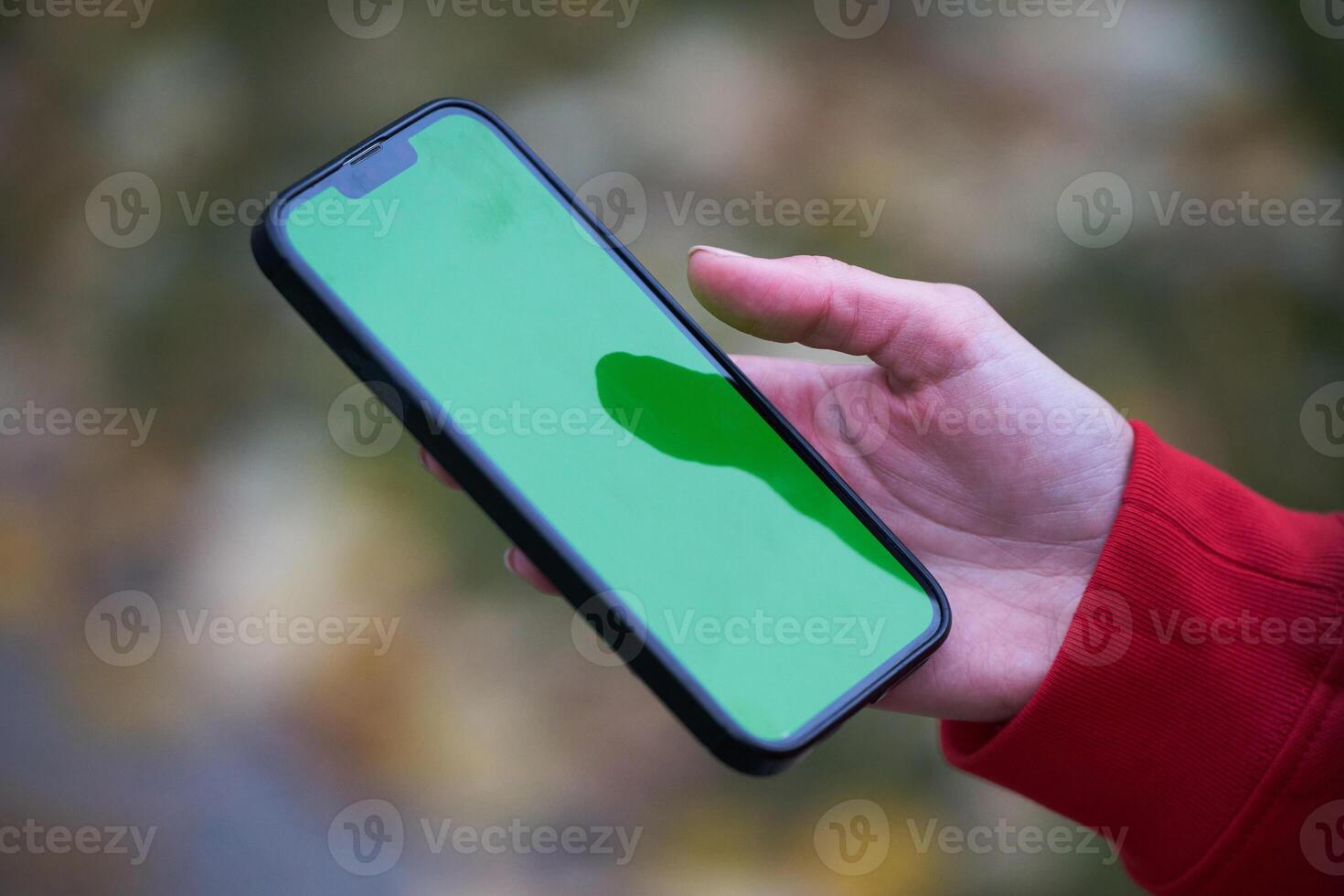 Tired fitness woman after workout and use smartphone with green screen photo