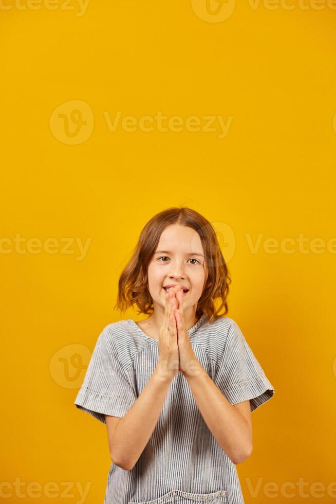 Teenage Schoolgirl Clapping Hands Against a Bright Yellow Background During Daytime photo