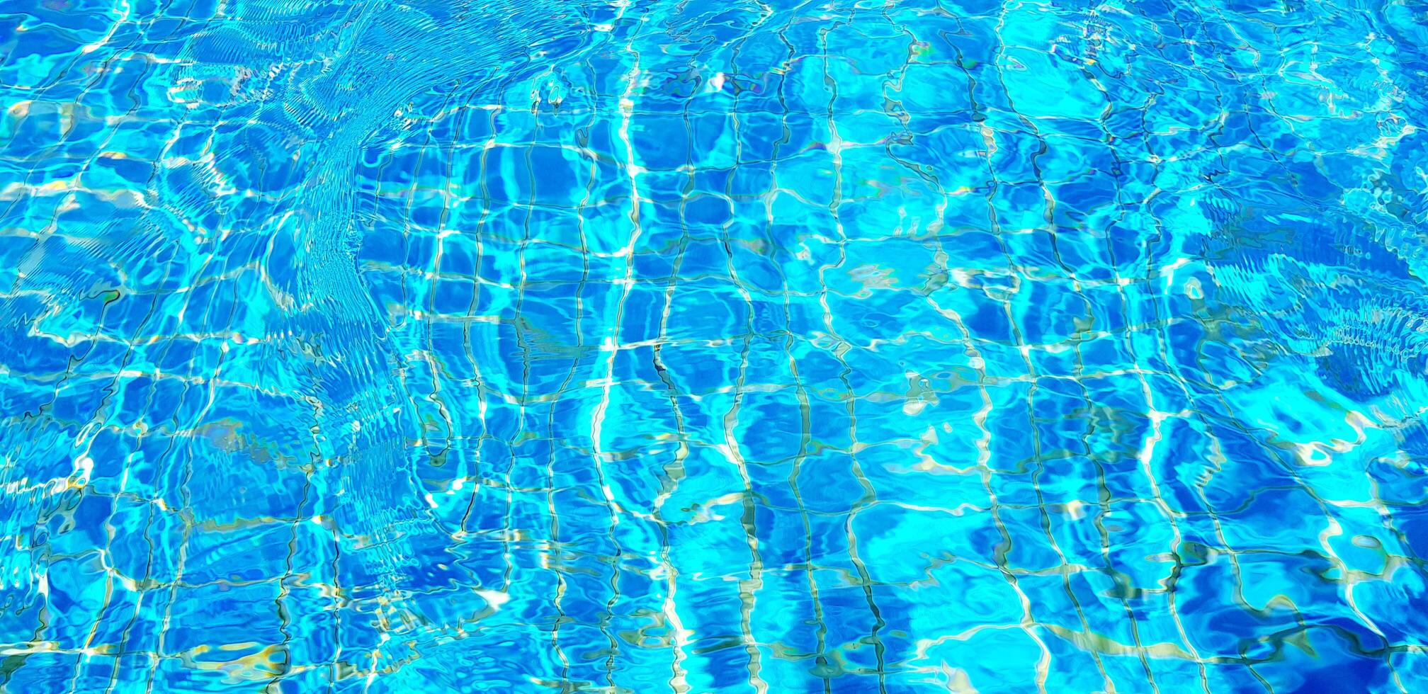 Wave or ripple water in swimming pool with sunlight reflection for background. Art or Abstract and Wallpaper concept. photo
