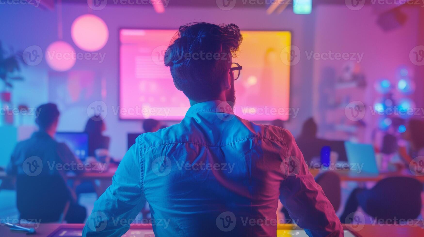 A team of professionals collaborating in a vibrant, high-tech workspace with colorful lighting and digital screens, focusing on a presentation. photo