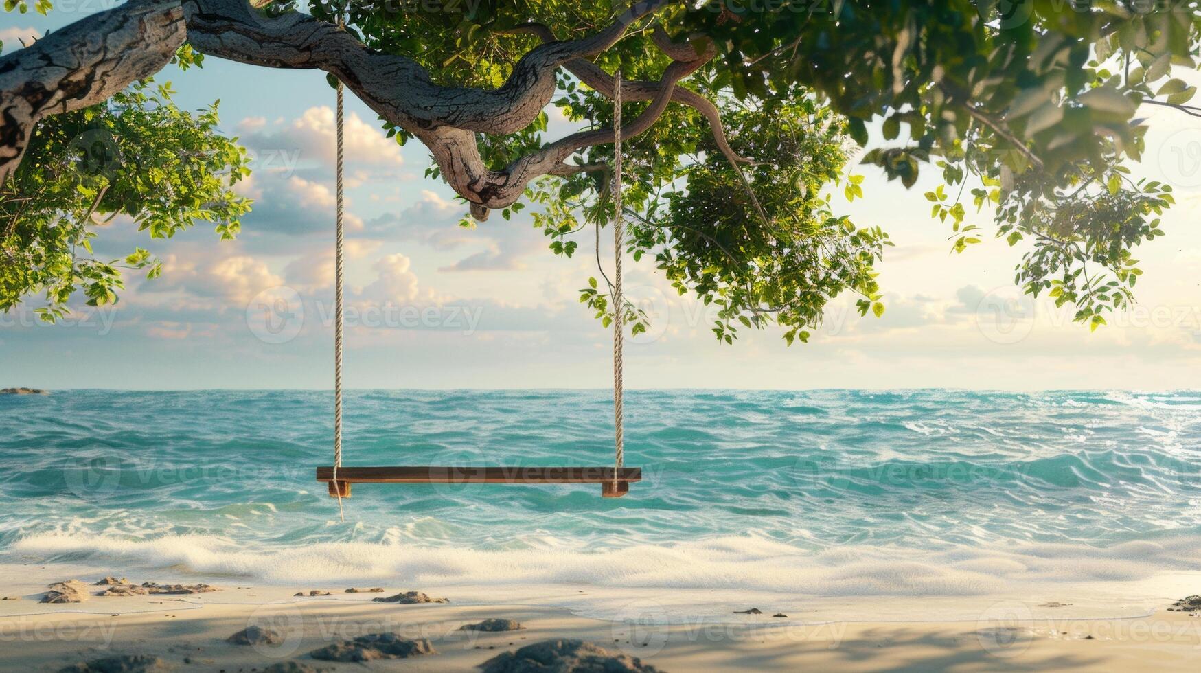 A serene wooden swing hangs from a tree branch, facing the tranquil ocean waves on a sunny beach. photo